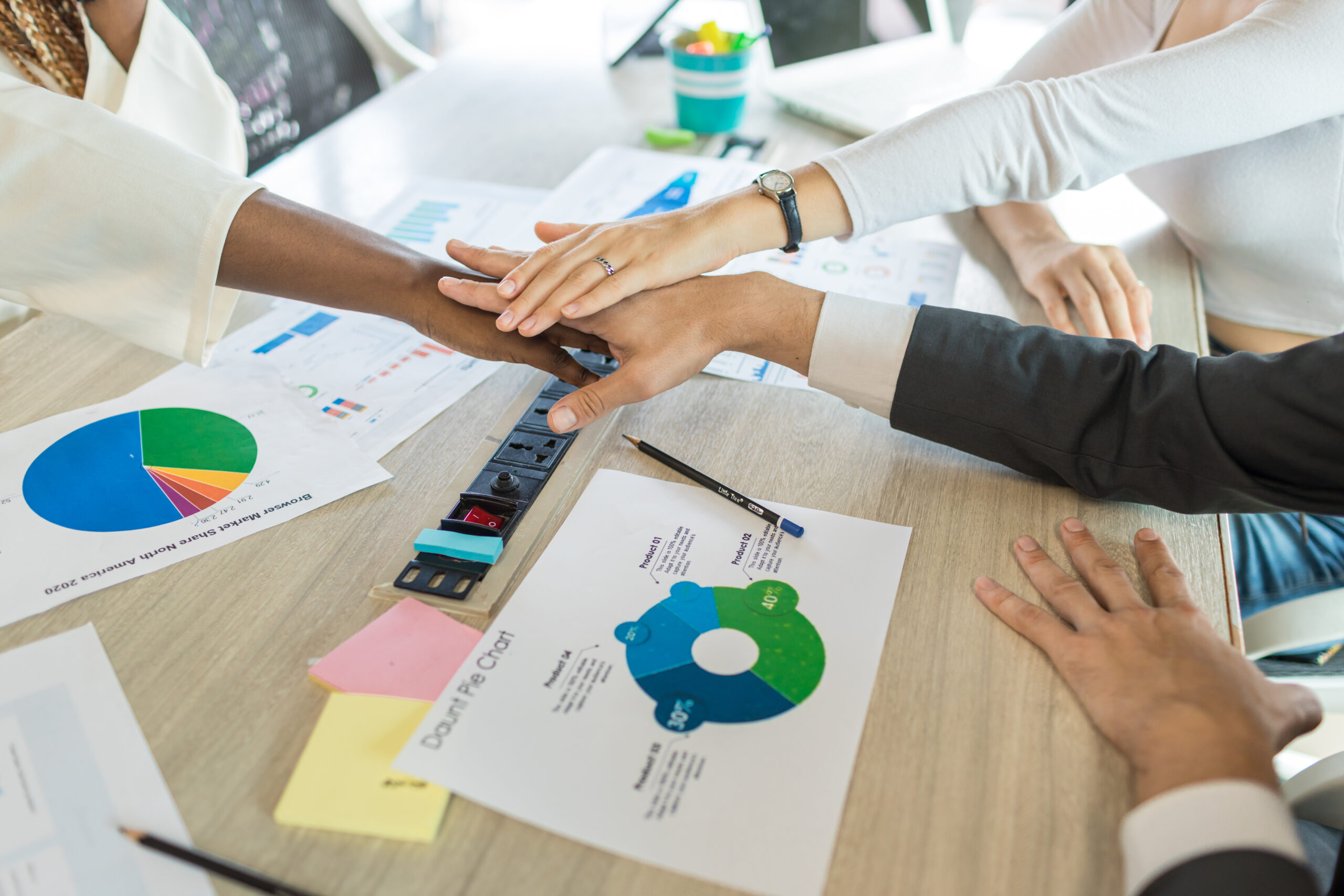 Diverse colleagues gather putting their hands together. Stack of hands. business people putting their hands together